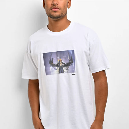 A man wearing a white crew-neck t-shirt with a rectangular graphic print on the chest depicting a sci-fi robot or mecha figure, set against a plain light gray background.